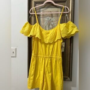 Yellow short Romper with Embroidery design on bottom of shorts.